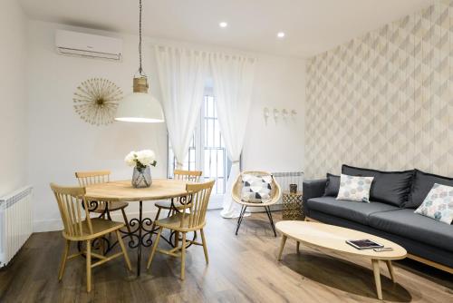 a living room with a couch and a table at Charming Madrid Center - Estancias Temporales in Madrid