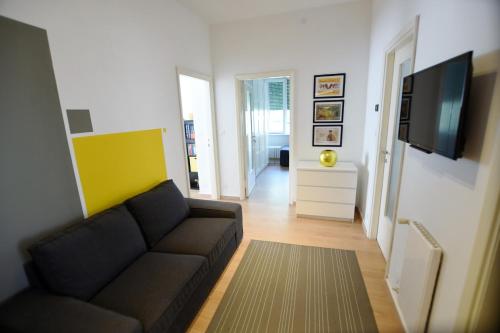 a living room with a couch and a flat screen tv at Le Rondinelle in Como