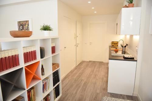 a kitchen with white shelves and a counter at Le Rondinelle in Como