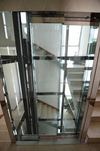 a glass elevator in a building with stairs at Le Rondinelle in Como