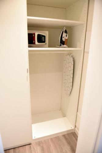 a closet with white walls and white shelves at Le Rondinelle in Como