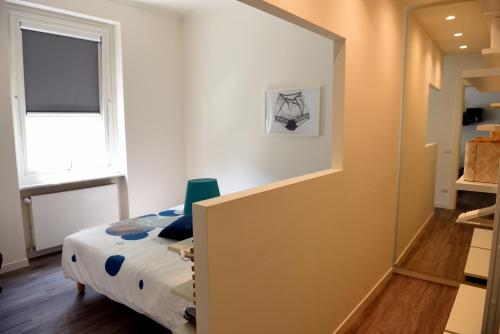 a small bedroom with a bed and a window at Le Rondinelle in Como