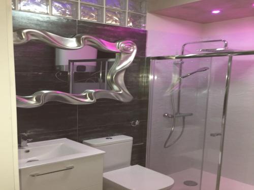 a bathroom with a shower and a toilet and a sink at Golden Paradise Seaview in Adeje