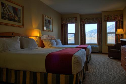 a hotel room with two beds and a window at Holiday Inn Hotel & Suites Osoyoos, an IHG Hotel in Osoyoos