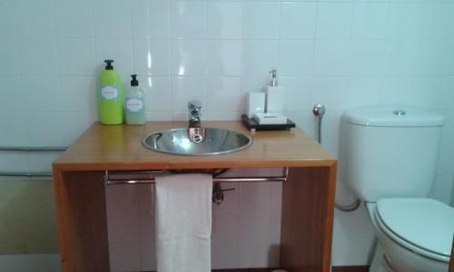 a bathroom with a sink and a toilet at Valmoa in Praia da Vitória