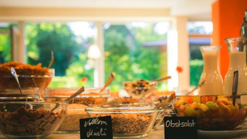 a table topped with bowls of food on a table at Ostel Jugendhotel Bremervörde in Bremervörde