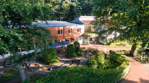 an aerial view of a house with trees and bushes at Ostel Jugendhotel Bremervörde in Bremervörde