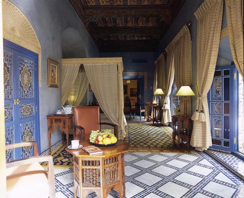 a room with blue walls and a table with fruit on it at Riyad Al Moussika in Marrakesh