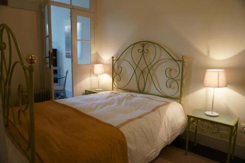 a bedroom with a bed and two lamps on tables at Baixa Apartamento in Bragança