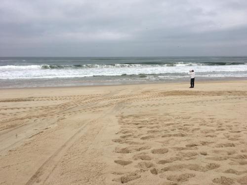 a man standing on a beach near the ocean at Praia de Mira in Praia de Mira