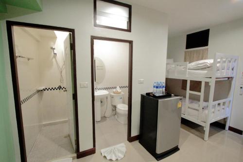 a bathroom with a shower and a toilet and a sink at BS Airport at Phuket in Nai Yang Beach