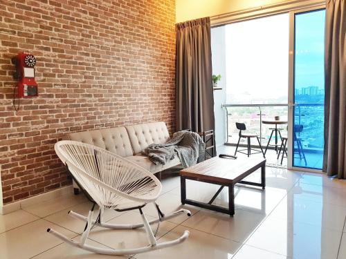 a living room with a couch and a brick wall at No.2 The Loft @Puchong Skypod Residence in Puchong