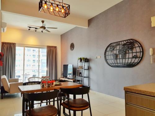 a kitchen and living room with a table and chairs at No.2 The Loft @Puchong Skypod Residence in Puchong
