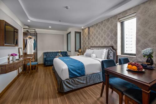 a hotel room with a bed and a table at Halina Hotel and Apartment in Da Nang