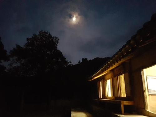 a full moon over a house at night at Jukheon Traditional House in Andong
