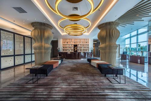 a lobby with two tall columns and a bar at Enso Hotel in Cikarang