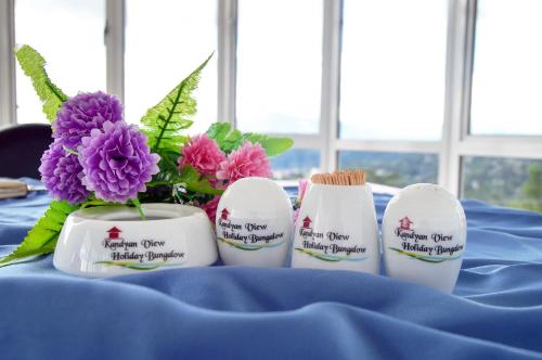 a blue table with some flowers and toothbrushes at Kandyan View Holiday Bungalow free pickup from kandy in Kandy