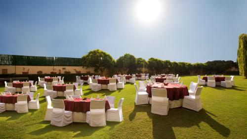 a group of tables and chairs in a field at Hotel Royal Orchid Jaipur, Tonk Road in Jaipur