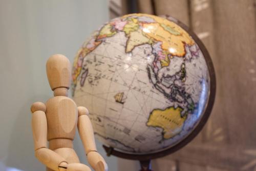 two dolls standing in front of a globe at H2H - Reunion House @ Majestic Ipoh 家好月圆 in Ipoh