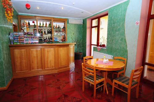 a dining room with a table and a bar at Chervona Gora in Mukacheve