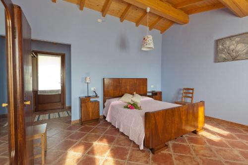 CavrianaにあるAgriturismo con Cucina tipica Nuova Scarduaのベッドルーム1室(花の飾られたベッド1台付)