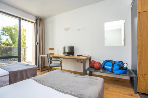 Ένα ή περισσότερα κρεβάτια σε δωμάτιο στο Park Hotel Asarel