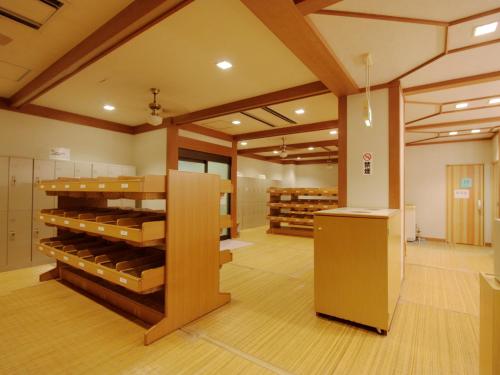 a large room with a wine cellar with wooden shelves at Yumoto Kanko Hotel Saikyo in Nagato