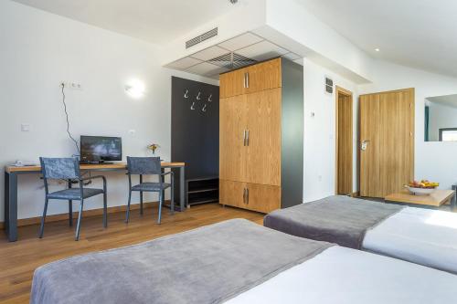 Ένα ή περισσότερα κρεβάτια σε δωμάτιο στο Park Hotel Asarel