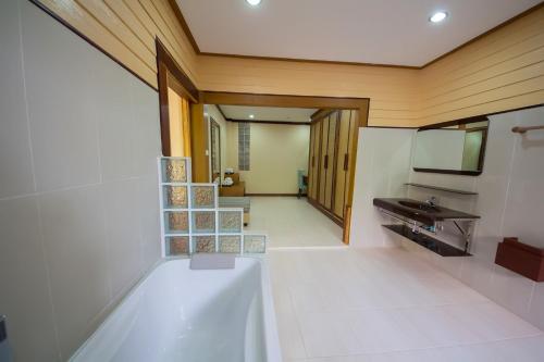 a bathroom with a sink and a mirror at Taman Resort in Phitsanulok