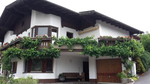 a white house with flowers on the balconies at Ferienwohnung Pupeter in Arzl im Pitztal
