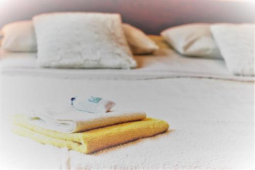 a bed with two beds with towels on it at Apartments Luce in Rovinj