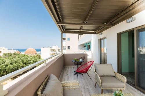 a balcony with chairs and a view of the ocean at Menta City Boutique Hotel in Rethymno Town