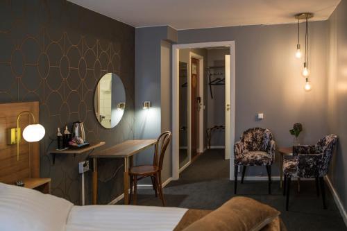 a hotel room with a bed and a table and chairs at Hotell Boras, BW Signature Collection in Borås