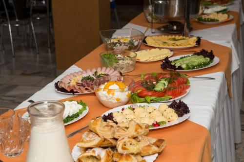 un lungo tavolo con piatti di cibo sopra di Domki Diament a Pobierowo