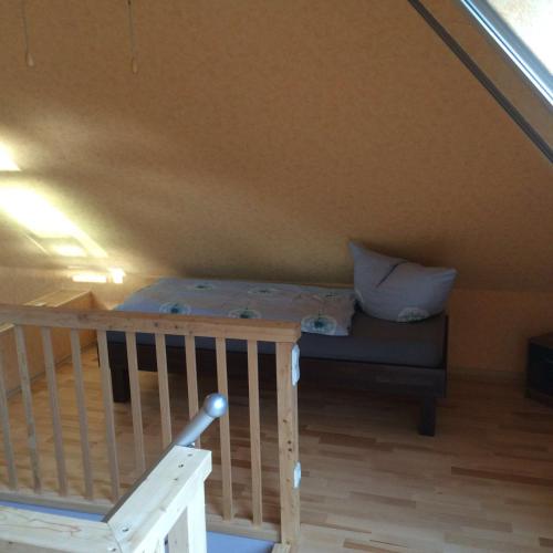 a bedroom with a bed in the attic at Moderne Maisonette-Wohnung am Karpfenteich; modern Apartment with view of the carp pond in Barmstedt