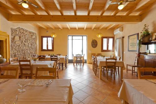 a restaurant with tables and chairs in a room at Agriturismo con Cucina tipica Nuova Scardua in Cavriana