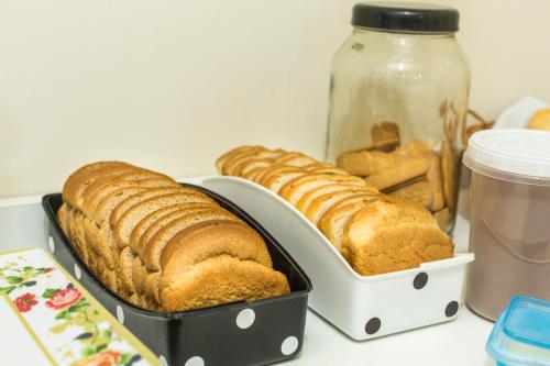 two trays of bread and a jar of food at Residencial Villa Container in Campinas