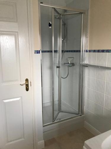 a shower with a glass door in a bathroom at The Lookout in Mundesley