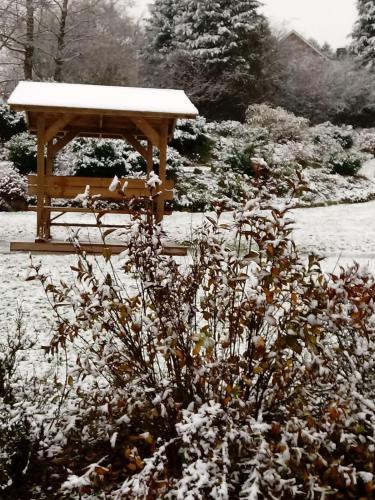 a gazebo in a garden with snow on it at La Métairie in Houffalize