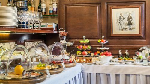 a buffet of food with fruits and vegetables on tables at Frederic Koklen Boutique Hotel in Odesa