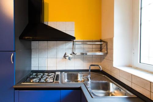 una cucina con lavandino e piano cottura di Bilo Bellezia a Torino