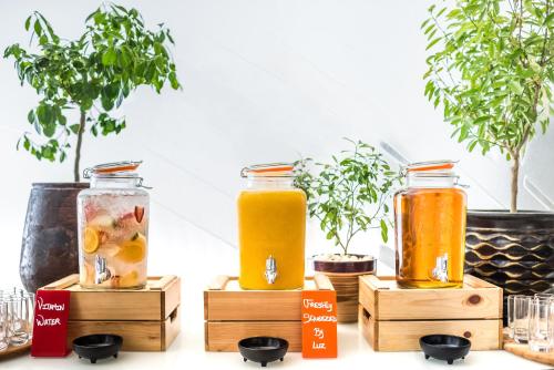 two glass jars filled with orange juice on wooden boxes at Park Inn by Radisson Istanbul Atasehir in Istanbul