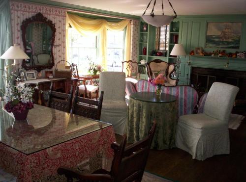 a living room with a table and chairs at Harborview Inn in Gloucester
