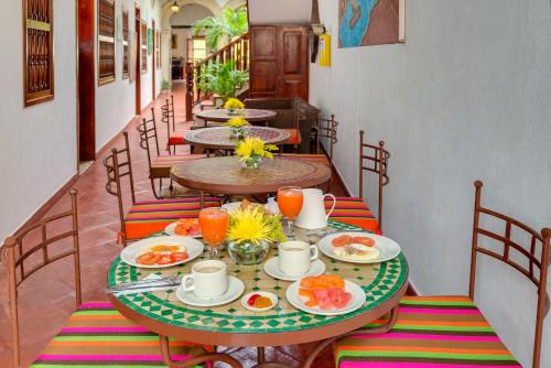 eine Gruppe von Tischen mit Speiseplatten darauf in der Unterkunft Casa Del Curato in Cartagena de Indias