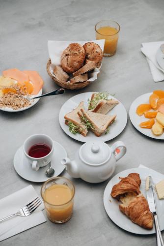 a table topped with plates of food and cups of coffee at MeetMe23 in Prague