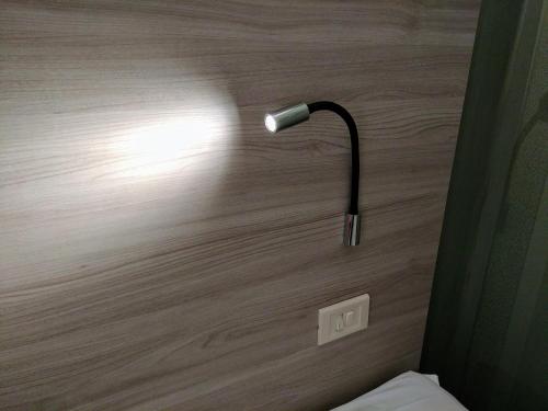 a lamp on a wall in a room at Hotel Vittoria in Genova