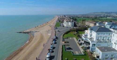 an aerial view of a beach with houses and cars at Hythe Imperial Hotel, Spa & Golf in Hythe