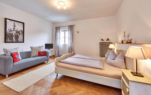 a bedroom with a large bed and a couch at Olympiahaus in Garmisch-Partenkirchen