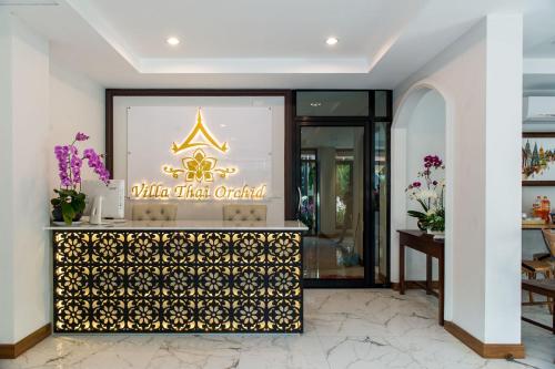 a lobby of a hotel with a sign on the wall at Villa Thai Orchid (adult only) in Chiang Mai