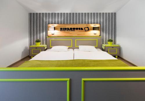 a bedroom with a large bed with a sign above it at Ridehouse in Schladming